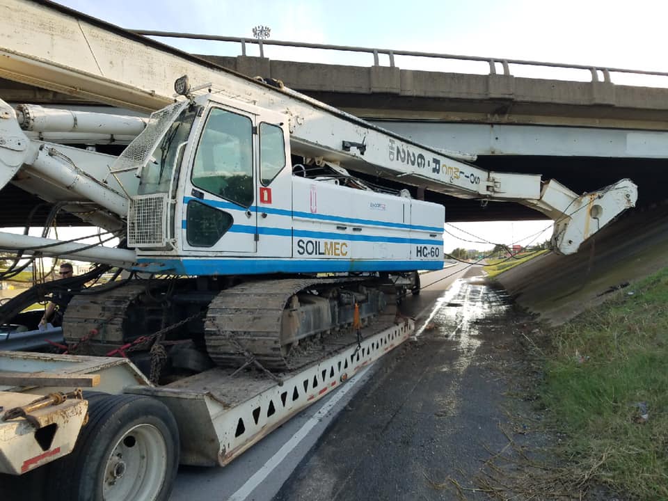 Drilling rig stuck under bridge at 820 and Highway 10.